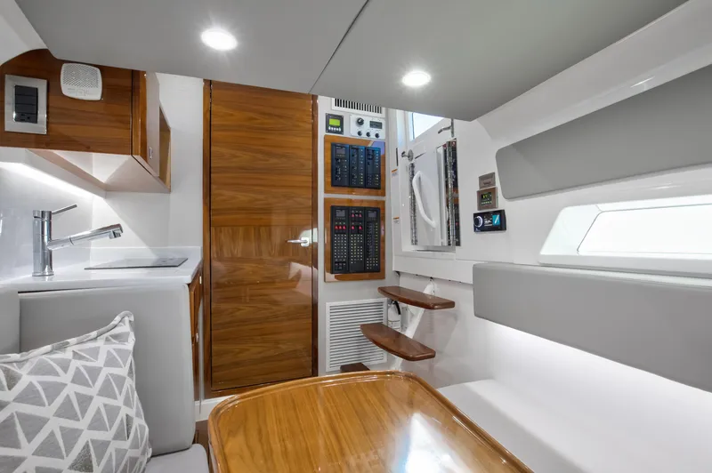 Slide: The Image of Interior of 2022 Valhalla Boatworks 46 Center Console, featuring modern wood and white design. - 17