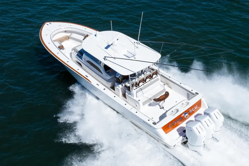 Slide: The Image of 2022 Valhalla Boatworks 46 Center Console cruising on open water, showcasing sleek design and powerful engines. - 2