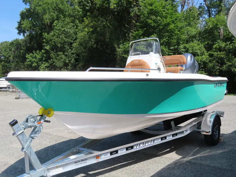 Slide: The Image of 2025 Key West 179 FS boat on trailer, vibrant teal hull, parked outdoors. - 0