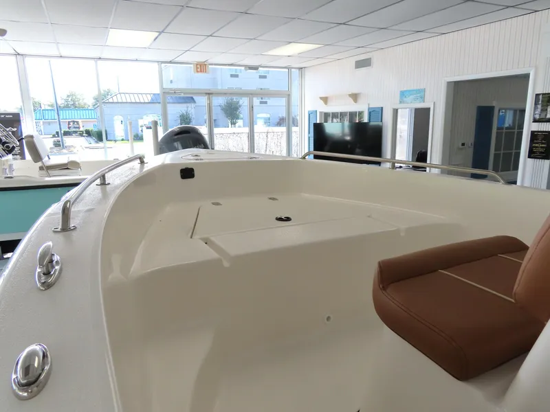 Slide: The Image of 2025 Key West 179 FS boat interior with seating in showroom. - 11