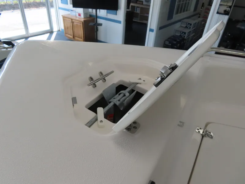 Slide: The Image of 2025 Key West 179 FS boat anchor storage compartment open in showroom. - 16