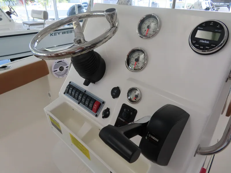 Slide: The Image of 2025 Key West 179 FS boat dashboard with steering wheel and gauges. - 19