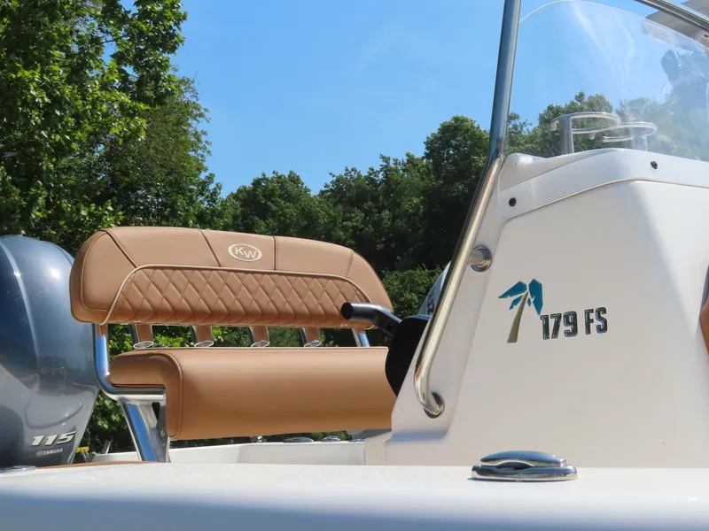 Slide: The Image of 2025 Key West 179 FS boat with tan seating and sleek design. - 2