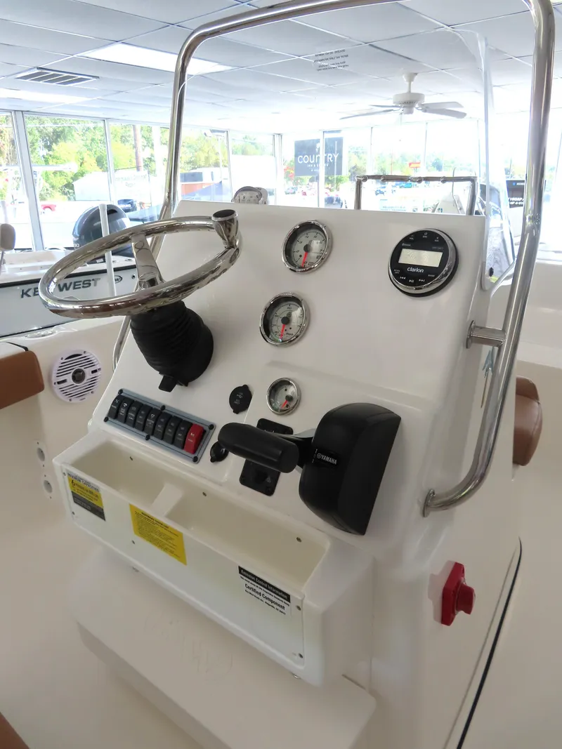 Slide: The Image of 2025 Key West 179 FS boat console with steering wheel and gauges in showroom. - 21
