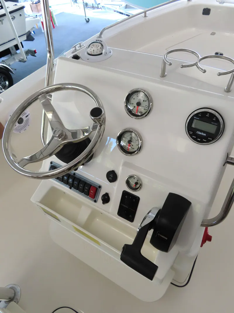 Slide: The Image of 2025 Key West 179 FS boat dashboard with steering wheel and gauges. - 22