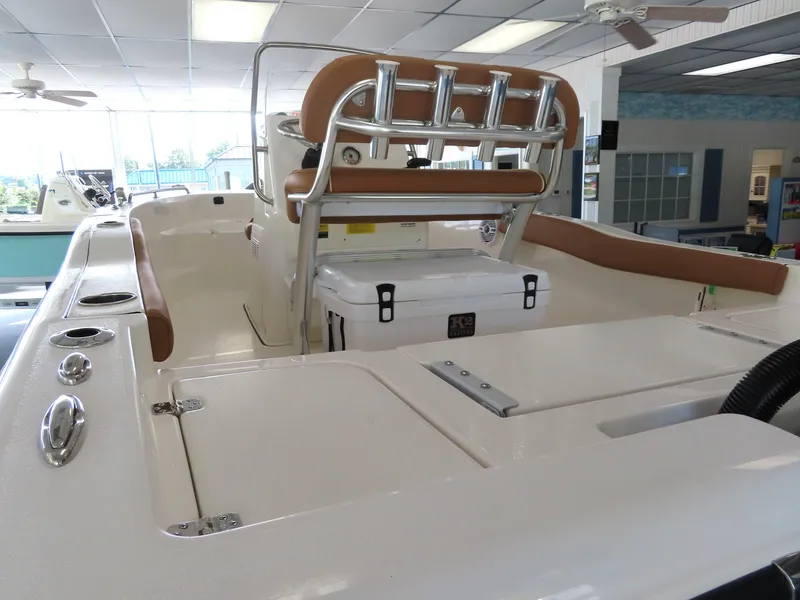 Slide: The Image of 2025 Key West 179 FS boat interior with seating and storage in showroom. - 25