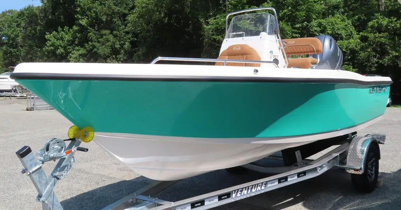 Slide: The Image of 2025 Key West 179 FS boat on trailer, teal hull, parked outdoors. - 4