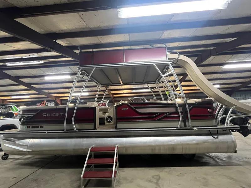 Slide: The Image of 2016 Crest 250 L pontoon boat with slide, parked indoors. - 0