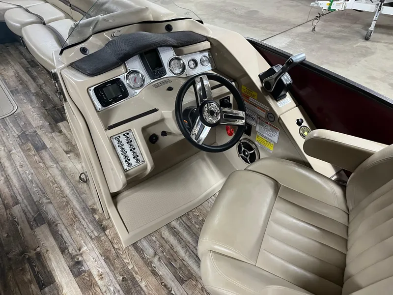 Slide: The Image of 2016 Crest 250 L boat interior with steering wheel and control panel. - 1