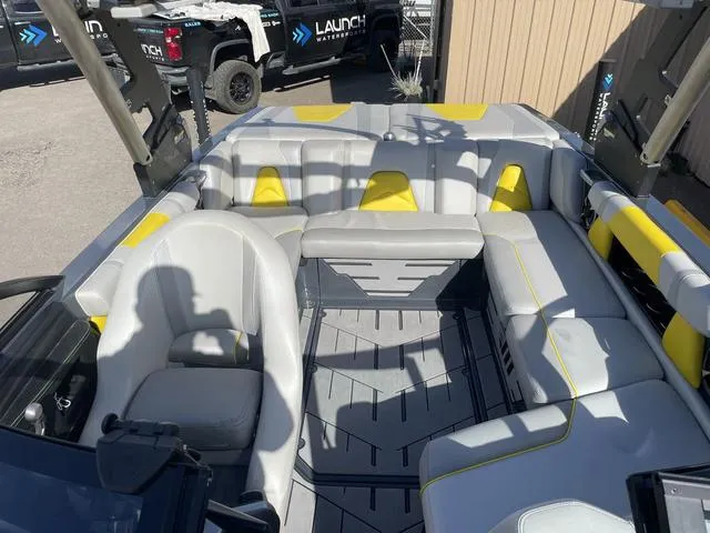 Slide: The Image of 2017 Malibu 21 VLX boat interior with gray and yellow seating. - 11