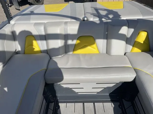 Slide: The Image of 2017 Malibu 21 VLX boat interior with gray and yellow seating. - 12