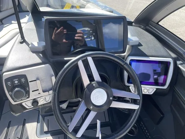 Slide: The Image of 2017 Malibu 21 VLX boat dashboard with steering wheel and digital displays. - 13