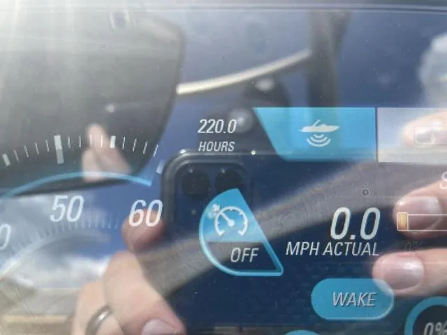 Slide: The Image of Dashboard of a 2017 Malibu 21 VLX boat showing 220 hours and speed controls. - 14