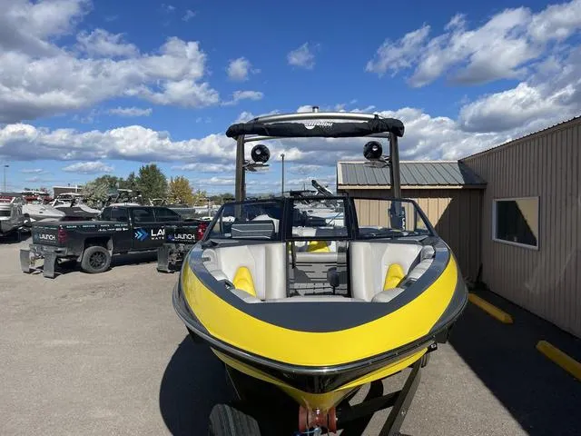 Slide: The Image of 2017 Malibu 21 VLX boat, yellow exterior, parked outdoors under a blue sky. - 6