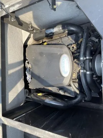 Slide: The Image of 2005 Malibu Sunsetter XTi engine compartment with visible components and hoses. - 12