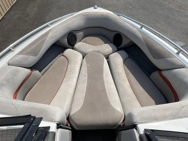Slide: The Image of 2005 Malibu Sunsetter XTi boat interior with cushioned seating and speakers. - 14