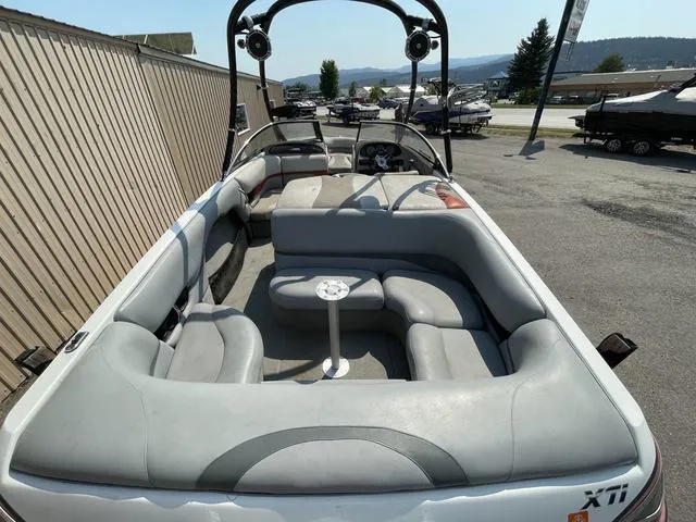 Slide: The Image of 2005 Malibu Sunsetter XTi boat with spacious seating and sleek design. - 6