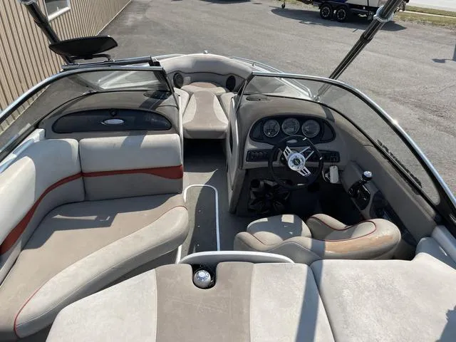 Slide: The Image of 2005 Malibu Sunsetter XTi boat interior with seating and dashboard view. - 7