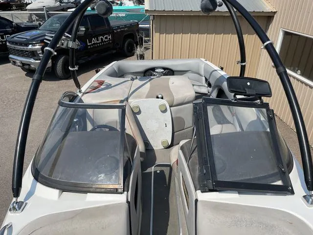 Slide: The Image of 2005 Malibu Sunsetter XTi boat interior with open windshield and seating area. - 9