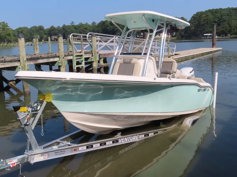 Slide: The Image of 2024 Key West 203 FS boat on trailer by a dock. - 10