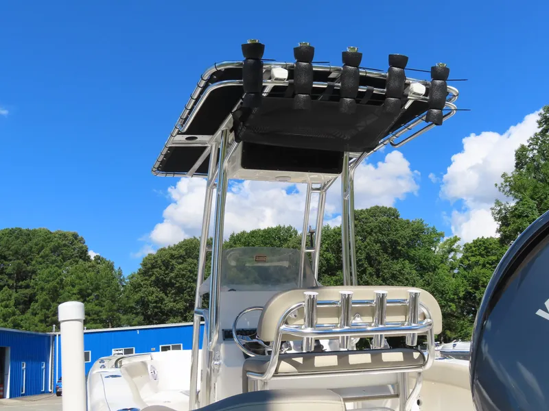 Slide: The Image of 2024 Key West 203 FS boat with T-top against blue sky and trees. - 16