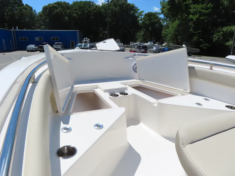 Slide: The Image of 2024 Key West 203 FS boat interior with open storage compartments and cup holders. - 17