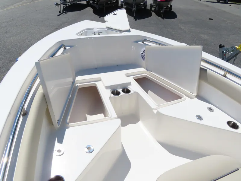 Slide: The Image of 2024 Key West 203 FS boat interior with open storage compartments and cup holders. - 19