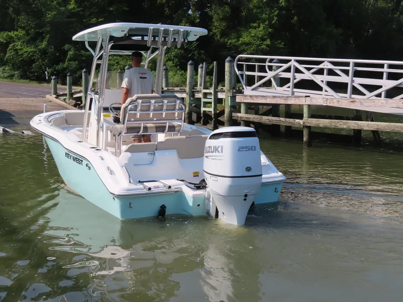 Slide: The Image of 2024 Key West 203 FS boat with Suzuki engine near a dock. - 28