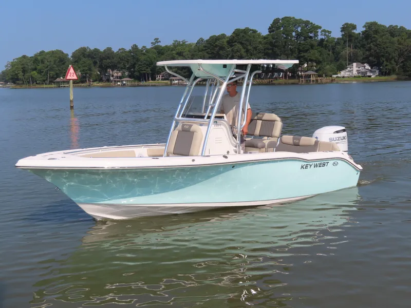 Slide: The Image of 2024 Key West 203 FS boat on calm water, featuring a sleek design and Suzuki engine. - 29