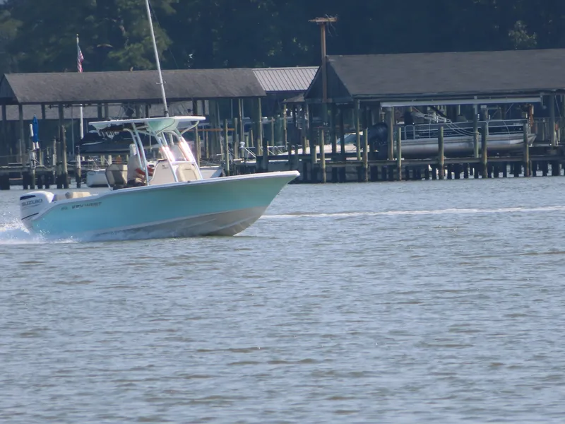 Slide: The Image of 2024 Key West 203 FS boat cruising near docks on a sunny day. - 30