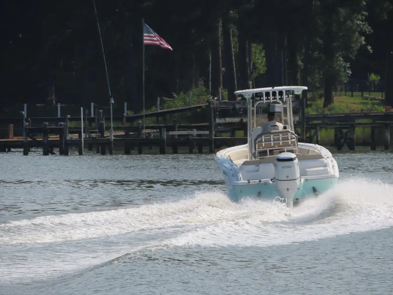 Slide: The Image of 2024 Key West 203 FS boat cruising on a lake near a dock. - 31