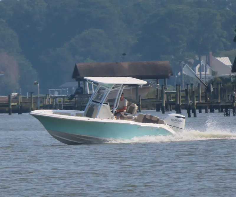 Slide: The Image of 2024 Key West 203 FS boat cruising on a calm river near docks. - 35