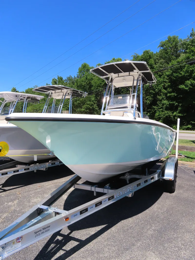 Slide: The Image of 2024 Key West 203 FS boat on trailer, parked outdoors under clear blue sky. - 5