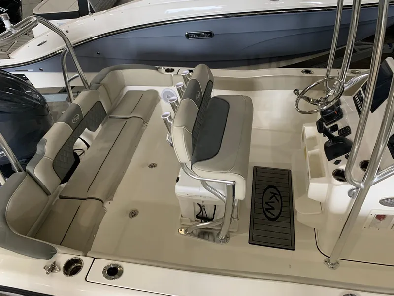 Slide: The Image of 2025 Key West 203 FS boat interior with seating and steering console. - 11