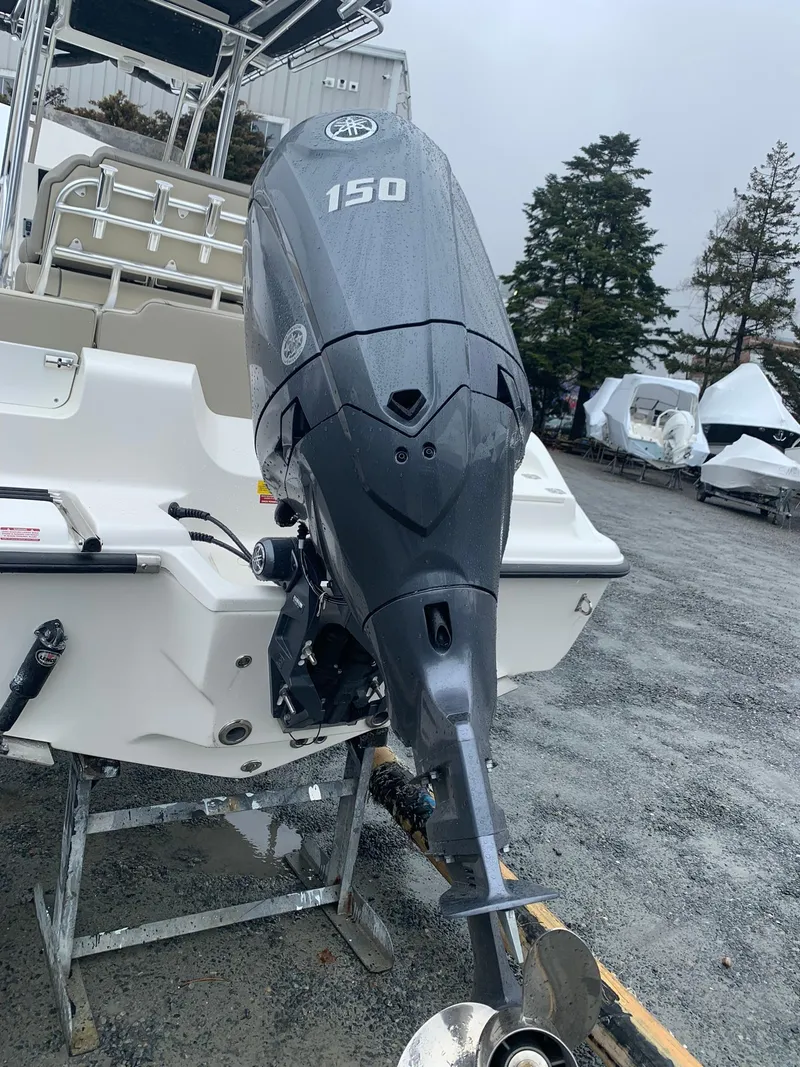 Slide: The Image of 2025 Key West 203 FS boat with Yamaha 150 outboard motor in a marina setting. - 2