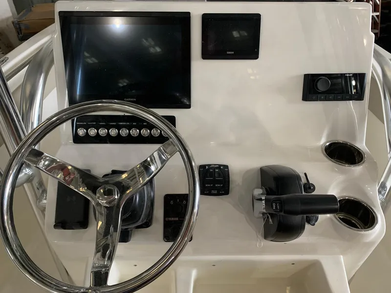 Slide: The Image of 2025 Key West 203 FS boat dashboard with steering wheel and control panel. - 5