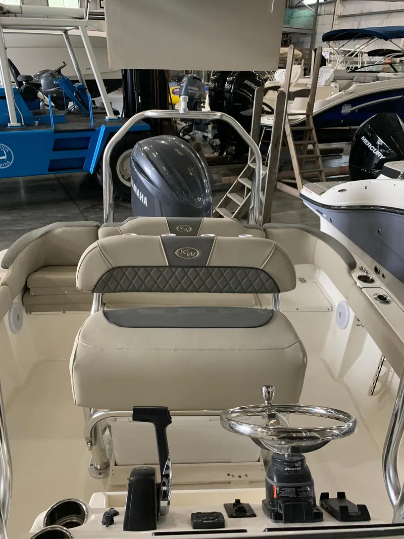 Slide: The Image of 2025 Key West 203 FS boat interior with Yamaha engine in a showroom. - 6