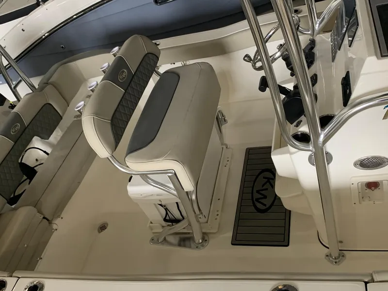 Slide: The Image of Interior of 2025 Key West 203 FS boat with cushioned seating and steering console. - 8