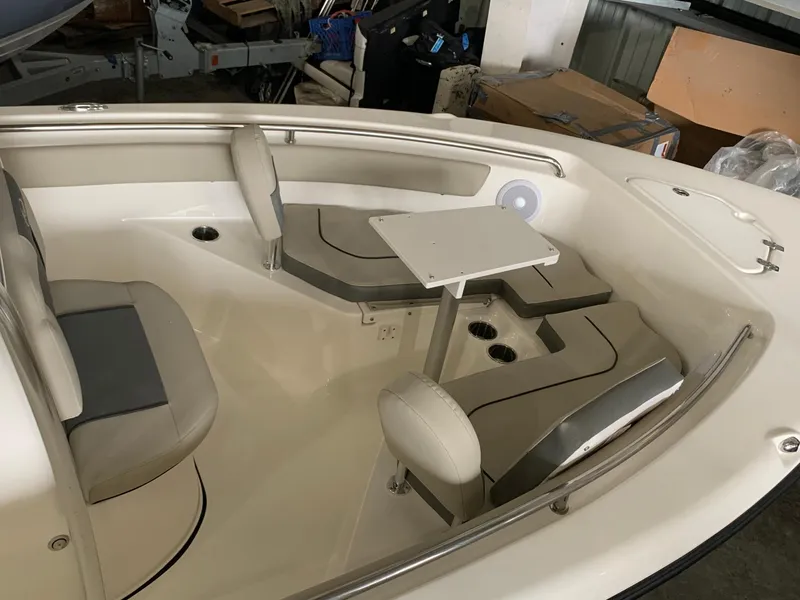 Slide: The Image of 2025 Key West 203 FS boat interior with seating and table in storage area. - 9