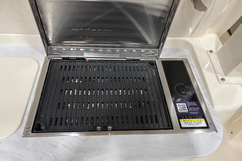 Slide: The Image of Built-in grill on 2026 Scout 330 LXF boat, featuring sleek design and modern controls. - 21