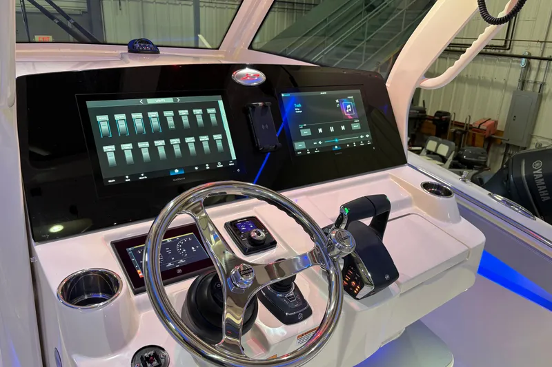 Slide: The Image of 2026 Scout 330 LXF boat dashboard with advanced touchscreen controls and steering wheel. - 25