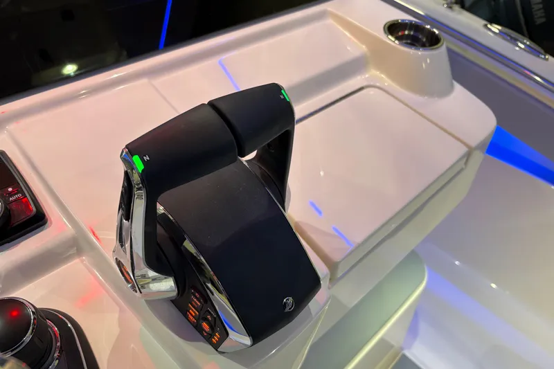 Slide: The Image of Throttle controls on 2026 Scout 330 LXF boat dashboard, featuring sleek design and modern technology. - 31