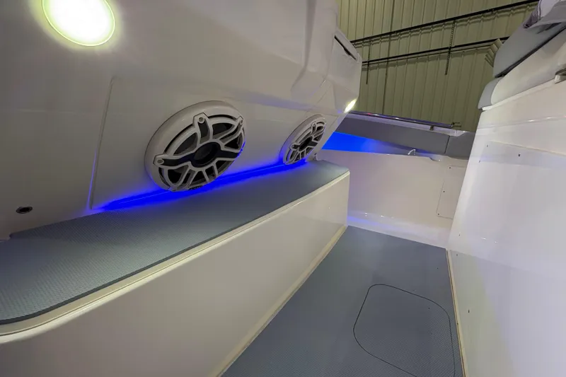 Slide: The Image of 2026 Scout 330 LXF boat interior with blue LED lighting and speaker system. - 32
