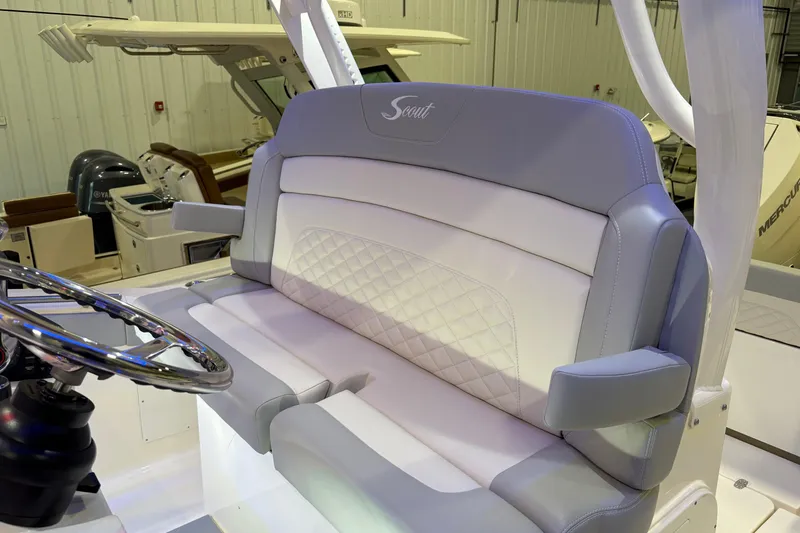 Slide: The Image of 2026 Scout 330 LXF boat interior with luxurious seating and steering wheel. - 33
