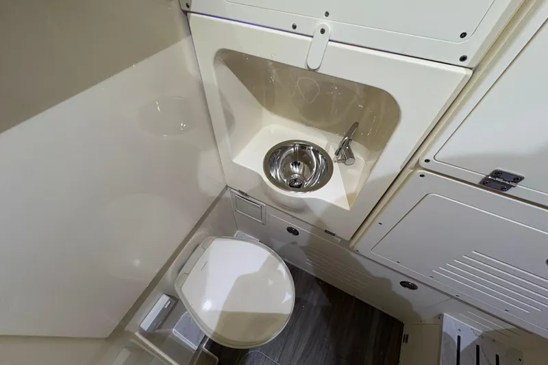 Slide: The Image of Compact bathroom in 2026 Scout 330 LXF boat with sink and toilet. - 43