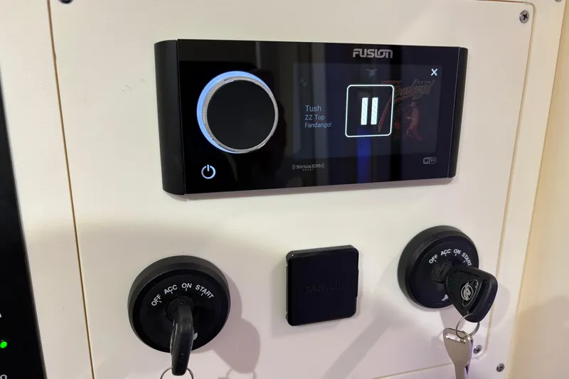 Slide: The Image of Control panel of 2026 Scout 330 LXF boat with audio system and ignition keys. - 44