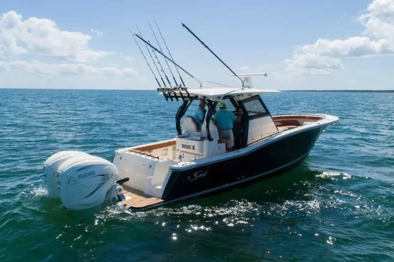 Slide: The Image of 2026 Scout 330 LXF boat in a spacious indoor marina setting. - 9