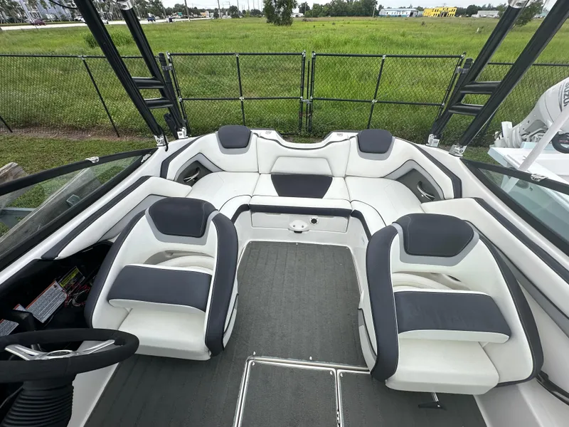 Slide: The Image of 2015 Yamaha Boats SX192 interior with white and gray seating, outdoor setting. - 14