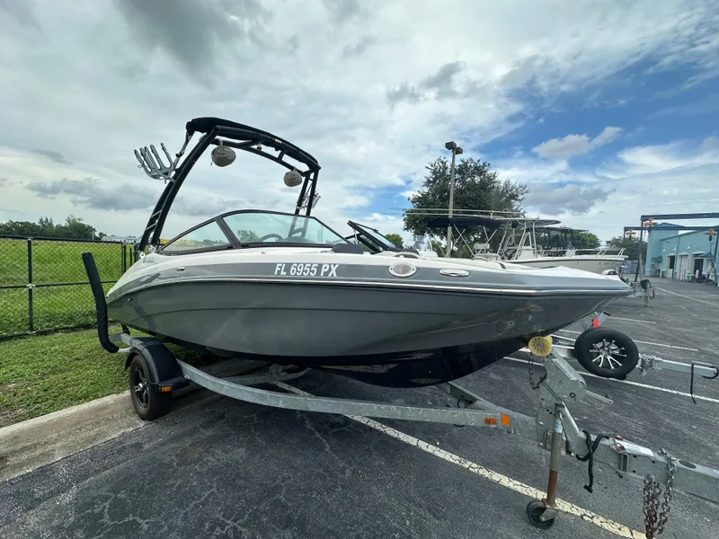 Slide: The Image of 2015 Yamaha Boats SX192 on trailer, parked outdoors under cloudy sky. - 6