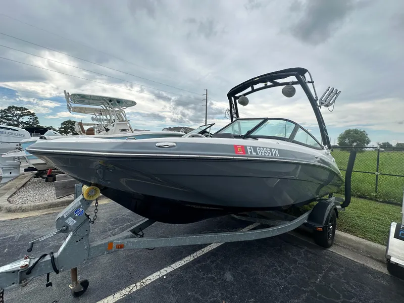 Slide: The Image of 2015 Yamaha Boats SX192 on trailer, parked outdoors under cloudy sky. - 7